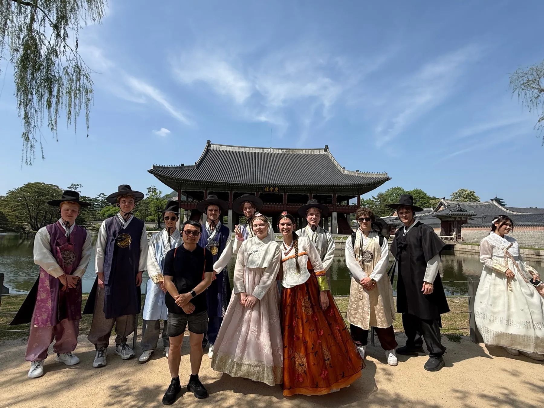 Students in traditional Korean clothing during a cultural visit in Seoul
