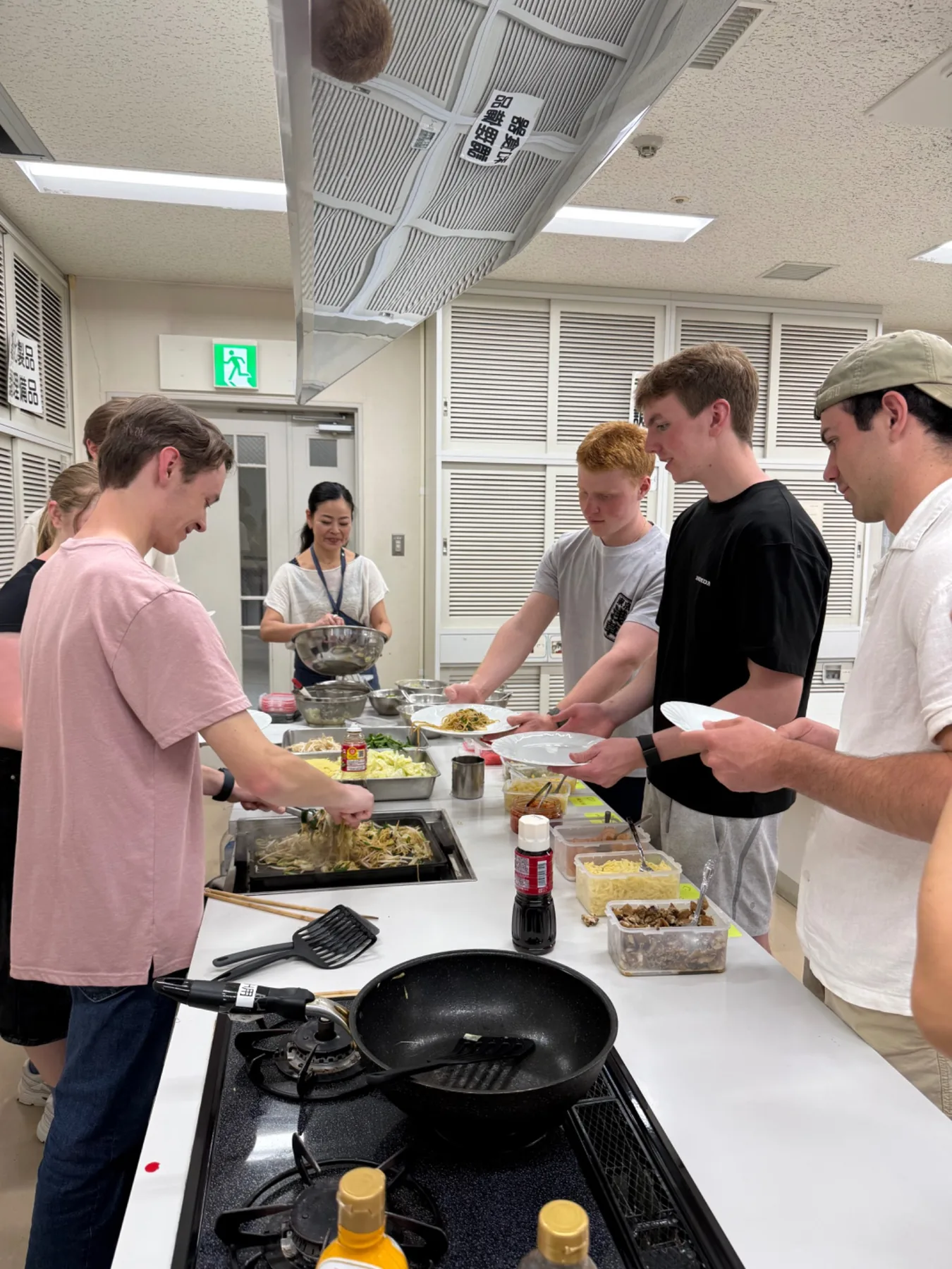 Students taking part in a hands-on cooking workshop in Japan